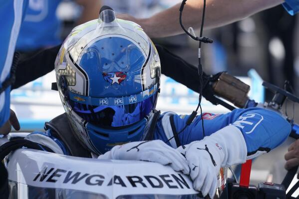 Josef Newgarden climbs into his car during a practice session for a IndyCar auto race at Indianapolis Motor Speedway, Friday, July 29, 2022, in Indianapolis. (AP Photo/Darron Cummings)