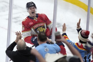 Florida Panthers center Anton Lundell celebrates after he scored the winning goal during an overtime period of an NHL hockey game against the Ottawa Senators, Tuesday, Feb. 20, 2024, in Sunrise, Fla. The Panthers beat the Senators 3-2 in overtime. (AP Photo/Wilfredo Lee)