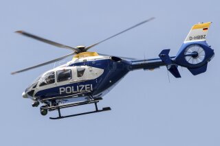 File---File picture taken May 11, 2017 shows a police helicopter flying over the A12 motorway near Briesen, Germany, Police say a 32-year-old Berlin man has been arrested on allegations he had been making radio contact with air traffic, including police helicopters, and given fake flight orders while impersonating an aviation official. (Patrick Pleul/dpa via AP)