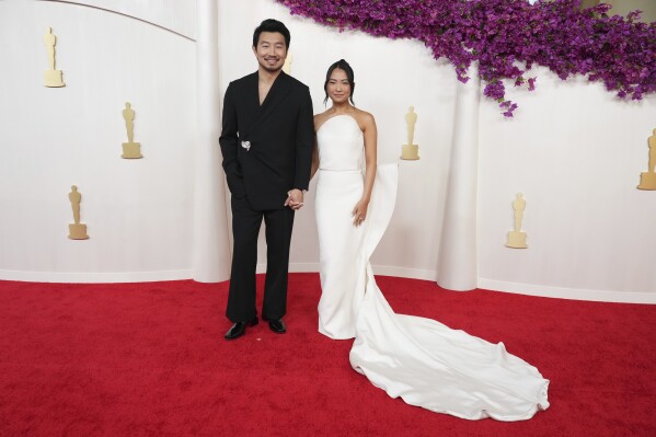 Simu Liu, left, and Allison Hsu arrive at the Oscars on Sunday, March 10, 2024, at the Dolby Theatre in Los Angeles. (Photo by Jordan Strauss/Invision/AP)