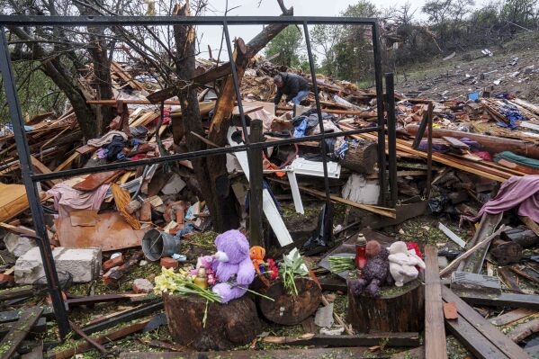 A man clears the rubble of a destroyed house where three children were killed by a Russian strike in Korostyshiv, Zhytomyr region, Ukraine, Sunday, May 25, 2025. (AP Photo/Evgeniy Maloletka)