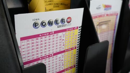 FILE - In this Jan. 12, 2021 file photo, blank forms for the Powerball lottery sit in a bin at a local grocery store, in Des Moines, Iowa.  Powerball tickets sold in Wisconsin and California were winners of the latest jackpot and will split $632 million. The winning numbers for the Powerball jackpot drawn Wednesday, Jan. 5, 2022. (AP Photo/Charlie Neibergall, File)