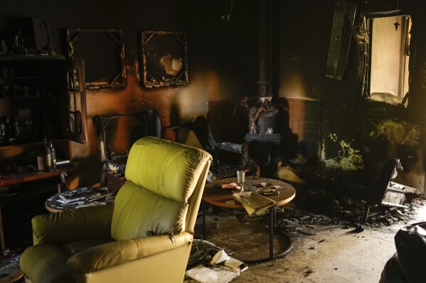 Destroyed furniture and charred walls are seen in a home that came under attack during a massive Hamas invasion into Kibbutz Nir Oz, Israel, Thursday, Oct. 19, 2023. Nir Oz is one of more than 20 towns and villages in southern Israel that were ambushed in the sweeping assault by Hamas on Oct. 7. The kibbutz on a low rise overlooking the border fence with Gaza suffered a particularly harsh toll. About 100 of Nir Oz's 400 people are dead or missing. (AP Photo/Francisco Seco)