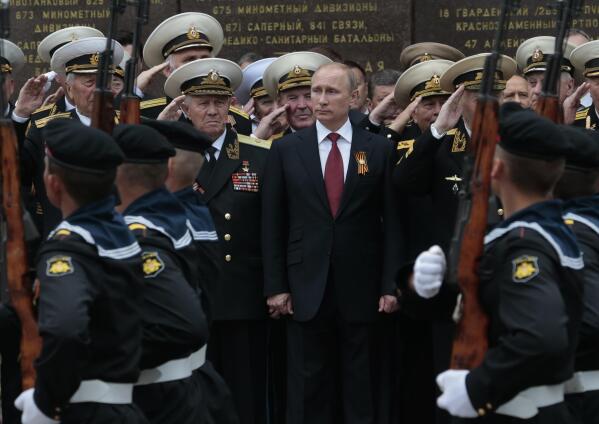 FILE - Russian President Vladimir Putin attends a parade marking the Victory Day in Sevastopol, Crimea, on May 9, 2014. Russia's present demands are based on Putin's purported long sense of grievance and his rejection of Ukraine and Belarus as truly separate, sovereign countries but rather as part of a Russian linguistic and Orthodox motherland. (AP Photo/Ivan Sekretarev, File)