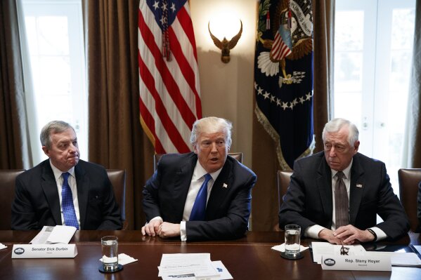 
              In this Jan. 9, 2017, photo, Sen. Dick Durbin, D-Ill., left, and Rep. Steny Hoyer, D-Md. listen as President Donald Trump speaks during a meeting with lawmakers on immigration policy in the Cabinet Room of the White House in Washington. Bargainers seeking a bipartisan immigration accord planned talks as soon as Wednesday as President Donald Trump and leading lawmakers sought to parlay an extraordinary White House meeting into momentum for resolving a politically blistering issue.(AP Photo/Evan Vucci)
            