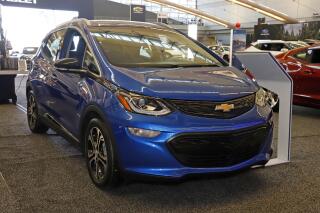 FILE - This Thursday, Feb. 13, 2020 file photo shows a 2020 Chevrolet Bolt EV on display at the 2020 Pittsburgh International Auto Show  in Pittsburgh. General Motors is recalling all Chevrolet Bolt electric vehicles sold worldwide to fix a battery problem that could cause fires. The recall raises questions about lithium ion batteries, which now are used in nearly all electric vehicles. President Joe Biden wants to convert 50% of the U.S. vehicle fleet from internal combustion to electricity by 2050 as part of a broader effort to fight climate change. The recall was announced Friday, Aug. 20, 2021. (AP Photo/Gene J. Puskar)