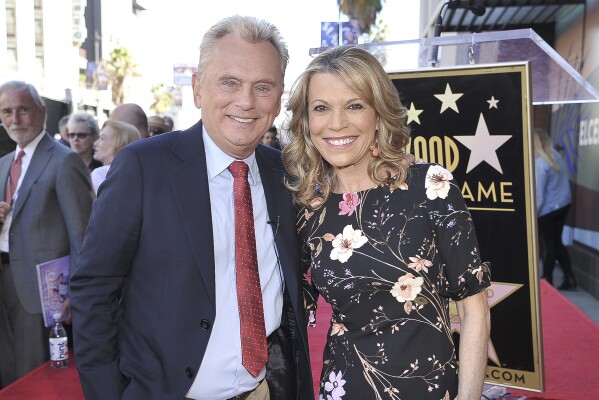 FILE - Pat Sajak, left, and Vanna White, from "Wheel of Fortune," attend a ceremony honoring Harry Friedman with a star on the Hollywood Walk of Fame in Los Angeles on Nov. 1, 2019. (Photo by Richard Shotwell/Invision/AP, File)