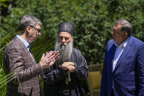 Serbian Orthodox Church Patriarch Porfirije, center, speaks with Serbian President Aleksandar Vucic, left, and Bosnian Serb leader Milorad Dodik in Belgrade, Serbia, Thursday, July 20, 2023. They talked about the situation in the region and upcoming important meetings between the delegations of the Republic of Serbia and the Republic of Srpska.(AP Photo/Darko Vojinovic)