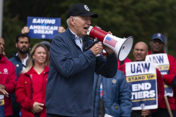 President Joe Biden speaks to striking United Auto Workers on the picket line outside the Willow Run Redistribution Center, UAW Local 174, Sept. 26, 2023, in Van Buren Township, Mich. Biden will be the keynote speaker Wednesday, Jan. 24, at a UAW political convention as he works to sway blue-collar workers his way in critical auto-making swing states such as Michigan and Wisconsin. (AP Photo/Evan Vucci, File)