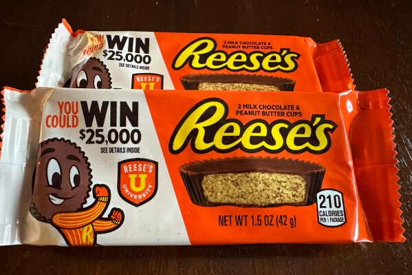 Two packages of Reese's candy featuring a sweepstakes ad are shown in Ann Arbor, MI., on Friday, Oct. 13, 2023. Reese's may be violating state and federal laws with the sweepstakes offer. (AP Photo/Dee-Ann Durbin)