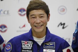 FILE - Space flight participant Yusaku Maezawa attends a news conference ahead of the expedition to the International Space Station at the Gagarin Cosmonauts' Training Center in Star City outside Moscow, Russia, on Oct. 14, 2021. Maezawa said Friday, Dec. 9, 2022 that K-pop star TOP will be among the eight crew members who will join him on a flyby around the moon on a SpaceX spaceship next year. (Shamil Zhumatov/Pool Photo via AP, File)