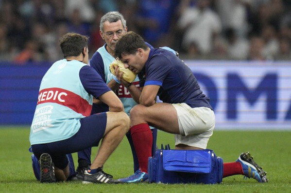 France's Antoine Dupont receives treatment after taking a knock to the head during the Rugby World Cup Pool A match between France and Namibia at the Stade de Marseille in Marseille, France, Thursday, Sept. 21, 2023. (AP Photo/Daniel Cole)