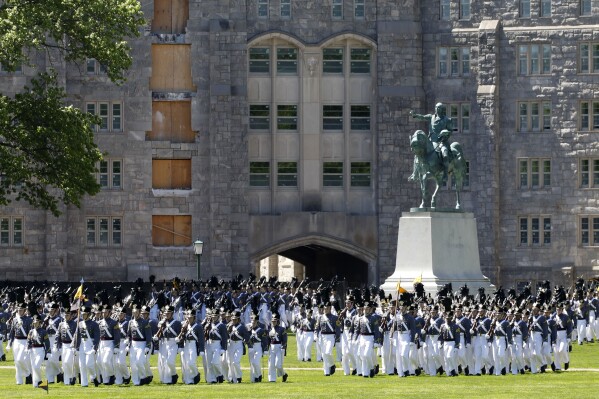 FILE - In this May 22, 2019 photo members of the senior class march past a statue of George Washington during Parade Day at the U.S. Military Academy in West Point, N.Y. "Duty, Honor, County" has been the motto of the U.S. Military Academy at West Point since 1898. The motto isn't changing, but a decision to take those words out of the school's lesser-known mission statement is generating outrage in certain quarters. (AP Photo/Mark Lennihan, File)