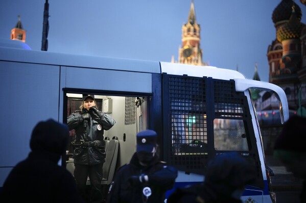FILE - A police officer stands inside a police bus with detained demonstrators during an antiwar protest near Red Square in Moscow, on Sept. 24, 2022. Russian authorities have adopted a slew of laws restricting fundamental human rights, including freedom of speech and assembly, as well as the rights of minorities and religious groups. (AP Photo, File)