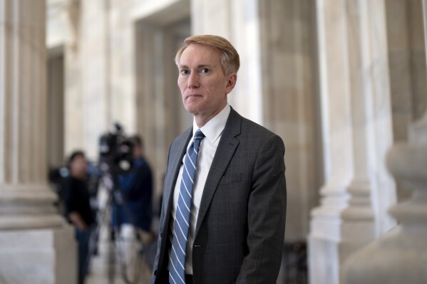Sen. James Lankford, R-Okla., the lead GOP negotiator on the Senate border and foreign aid package, does a TV news interview at the Capitol in Washington, Monday, Feb. 5, 2024. (AP Photo/J. Scott Applewhite)