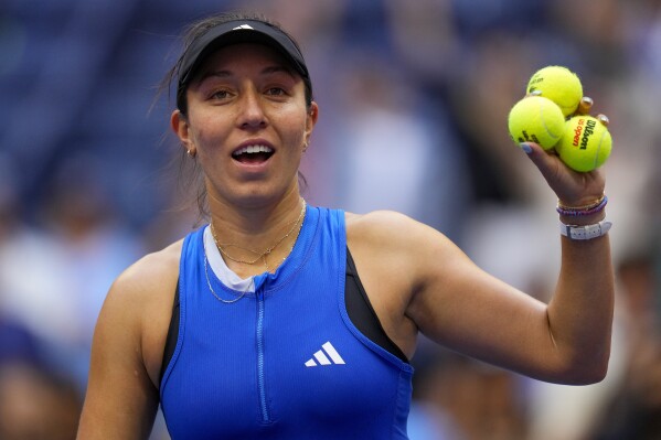Jessica Pegula, of the United States, prepares to hit tennis balls into the crowd after defeating Elina Svitolina, of Ukraine, during the third round of the U.S. Open tennis championships, Saturday, Sept. 2, 2023, in New York. (AP Photo/Manu Fernandez)