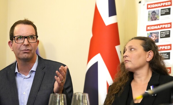 Noam Sagi, left, speaks alongside Ayelet Svatitzky during a press conference with families of hostages taken after the Oct. 7 assault by Hamas militants, at the Israeli Embassy in London, Tuesday, Oct. 24, 2023. More than 200 Israelis and foreigners were taken hostage on Oct. 7 after Hamas militants infiltrated Israel and went on a killing spree that claimed the lives of more than 1,400 people. (AP Photo/Kirsty Wigglesworth)