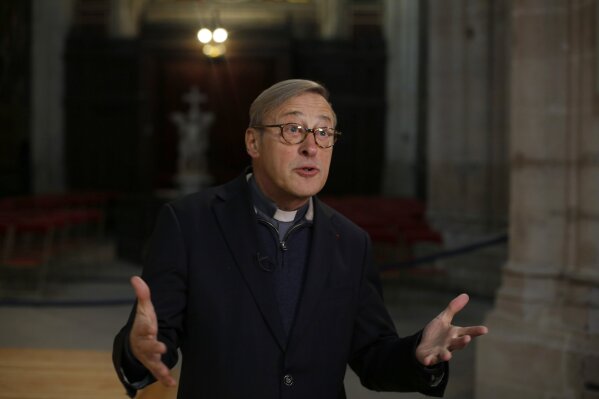 In this photo taken on Tuesday Dec. 3, 2019, Notre Dame cathedral rector Patrick Chauvet talks to the Associated Press, in Saint-Germain l'Auxerrois church, in Paris. Notre Dame Cathedral kept holding services during two world wars as a beacon of hope amid bloodshed and fear. It took a fire in peacetime to finally stop Notre Dame from celebrating Christmas Mass for the first time in more than two centuries. (AP Photo/Thibault Camus)