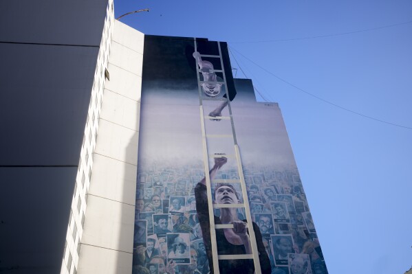 A mural covers the AMIA Jewish center in Buenos Aires, Argentina, Tuesday, Jan. 23, 2024. It was the worst bombing attack on civilians in Argentina’s history, killing 85 and injuring 300. It came two years after a 1992 bombing on the Israeli embassy in Argentina, killing 29. (AP Photo/Natacha Pisarenko)