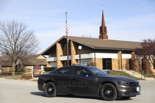 The Washington County Sheriff's office investigates the scene of a fatal stabbing on a Catholic priest in the rectory of St. John the Baptist Church, Sunday, Dec. 10, 2023, in Fort Calhoun, Neb. The Rev. Stephen Gutgsell died at an Nebraska hospital, according to a statement from the Archdiocese of Omaha. Police say a person is in custody. (Nikos Frazier/Omaha World-Herald via AP)