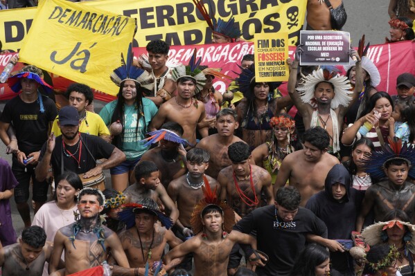 Indigenous people march during the annual Free Earth camp, where Brazil's Indigenous communities discuss rights, territorial protection and their role in COP30, which will take place for the first time in the Amazon, in Brasilia, Brazil, Tuesday, April 8, 2025. (AP Photo/Eraldo Peres)