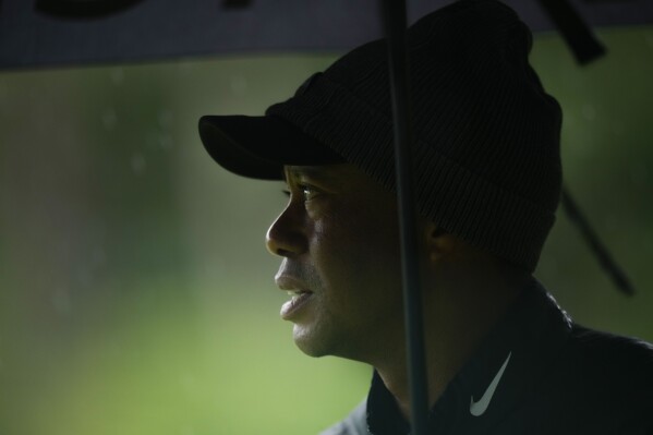 FILE - Tiger Woods watches on the 13th hole during the weather delayed third round of the Masters golf tournament at Augusta National Golf Club on April 8, 2023, in Augusta, Ga. Tiger Woods has joined the PGA Tour policy board for the first time in his 27 years. He has given Commissioner Jay Monahan key support and the players a greater voice as the tour tries to complete its business partnership with the Saudi backers of LIV Golf. Woods is joining as a sixth player director on the board. (AP Photo/Matt Slocum, file)