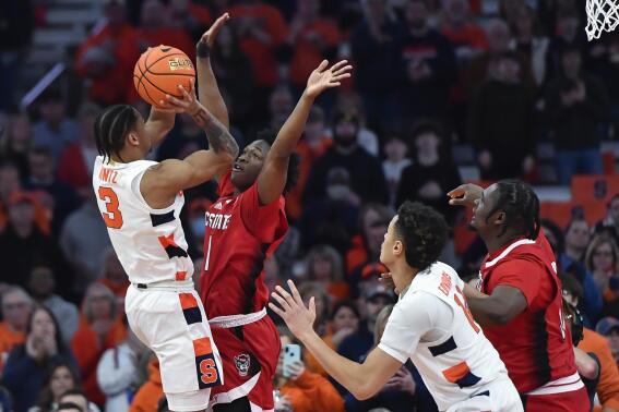 Syracuse guard Judah Mintz, left, shoots while defended by North Carolina State guard Jarkel Joiner during the first half of an NCAA college basketball game in Syracuse, N.Y., Tuesday, Feb. 14, 2023. (AP Photo/Adrian Kraus)