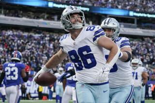 FILE - Dallas Cowboys tight end Dalton Schultz (86) celebrates after catching a touchdown pass against the New York Giants during the third quarter of an NFL football game, Sunday, Dec. 19, 2021, in East Rutherford, N.J. The Dallas Cowboys are using the franchise tag on tight end Dalton Schultz, buying time to agree on a long-term deal for one of Dak Prescott's most reliable targets, a person with knowledge of the decision said Tuesday, March 8, 2022. (AP Photo/Seth Wenig, File)