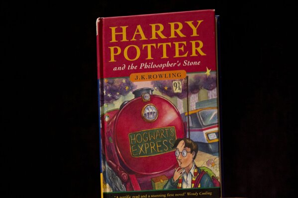 FILE - This May 20, 2013, file photo shows a first edition copy of the first Harry Potter book "Harry Potter and the Philosopher's Stone" during a photocall organized for the media at the Sotheby's auction house's premises in London. A Catholic school in Tennessee has removed the Harry Potter books from its library after the school's priest decided they could cause a reader to conjure evil spirits. (ĢӰԺ Photo/Matt Dunham, File)