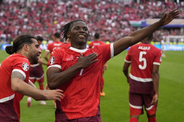 Switzerland's Breel Embolo celebrates after scoring his side's third goal during a Group A match between Hungary and Switzerland at the Euro 2024 soccer tournament in Cologne, Germany, Saturday, June 15, 2024. (AP Photo/Darko Vojinovic)