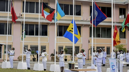 Members of the Trinidad and Tobago Defence Force raise the flags of CARICOM nations during a flag raising ceremony at the Convention Centre in Chaguaramas, Trinidad and Tobago, Tuesday, July 4, 2023. Tuesday marks the 50th Anniversary of the signing of the Treaty of Chaguaramas, which established the Caribbean Community, CARICOM. (AP Photo/Curtis Chase)
