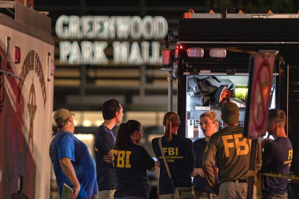FILE - FBI agents gather at the scene of a deadly shooting at the Greenwood Park Mall in Greenwood, Ind., on July 17, 2022. Five months after a 20-year-old man shot five people, three of them fatally, at the suburban Indianapolis mall, police and the FBI could shed light Wednesday, Dec. 21, 2022, on the gunman’s motive and whether any data could be extracted from his damaged cellphone. (Kelly Wilkinson/The Indianapolis Star via AP, File)