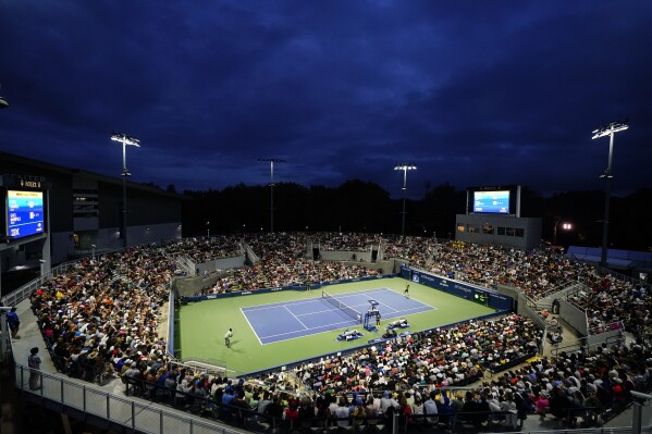 Taro Daniel, of Japan, right, serves to Gael Monfils, of France, during the first round of the U.S. Open tennis championships, Tuesday, Aug. 29, 2023, in New York. (AP Photo/Frank Franklin II)