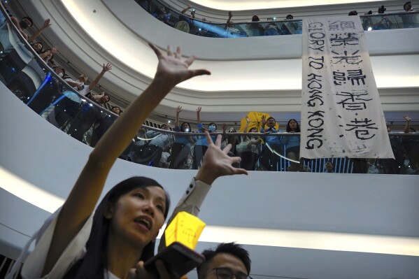 FILE - Demonstrators sing a theme song written by protestors "Glory to Hong Kong" at the Times Square shopping mall in Hong Kong, Thursday, Sept. 12, 2019. The Hong Kong government was given the green light on Wednesday, Aug. 23, 2023 to appeal a court's refusal to ban a protest song, after government lawyers cited national security concerns. (AP Photo/Vincent Yu, File)