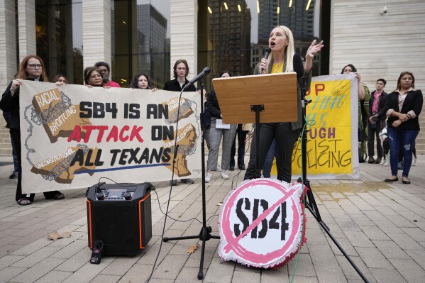 Kristin Etter, of the Texas Immigration Law Council, speaks at a news conference before a court hearing about the constitutionality of Senate Bill 4 at the U.S. Federal Courthouse in Austin, Texas, Thursday, Feb. 15, 2024. The Texas bill allows police to arrest migrants who illegally cross the U.S. border and give local judges authority to order them to leave the country. Opponents have called the measure the most dramatic attempt by a state to police immigration since a 2010 Arizona law — denounced by critics as the “Show Me Your Papers” bill — that was largely struck down by the U.S. Supreme Court. Immigration enforcement is a federal responsibility. (Jay Janner/Austin American-Statesman via AP)