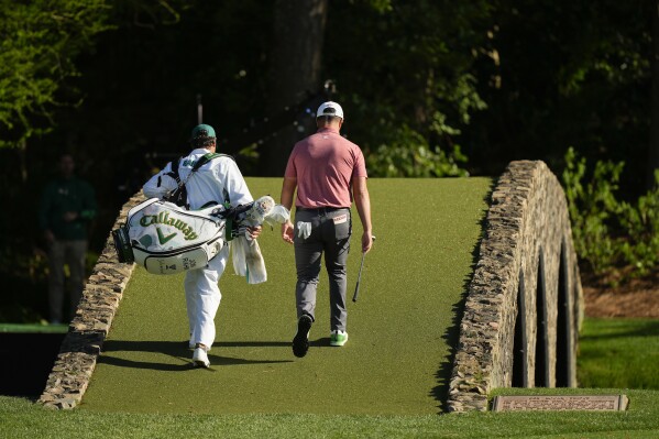 FILE - Jon Rahm, of Spain, walks over the bridge on the 12th hole during the final round of the Masters golf tournament at Augusta National Golf Club on Sunday, April 9, 2023, in Augusta, Ga. Rahm said his 9-iron to the middle of the 12th green was one shot he'll remember. (AP Photo/Charlie Riedel, File)