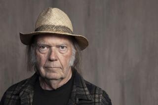 FILE - Neil Young poses for a portrait at Lost Planet Editorial in Santa Monica, Calif. on Sept. 9, 2019.  Young isn't satisfied with urging his fellow musicians to join him in taking their music off the streaming service Spotify. Now he wants company employees to quit their jobs before it “eats up your soul." In a message on his website Monday, Feb. 7, 2022, Young said company CEO Daniel Ek is a bigger problem than popular podcaster Joe Rogan.  (Photo by Rebecca Cabage/Invision/AP, File)
