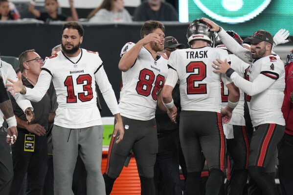 Tampa Bay Buccaneers' Mike Evans (13) celebrates with teammates Cade Otton (88), Kyle Trask (2) and Baker Mayfield (6) after Trask threw a touchdown during the first half of a preseason NFL football game against the Tampa Bay Buccaneers, Saturday, Aug. 19, 2023, in East Rutherford, N.J. (AP Photo/Seth Wenig)