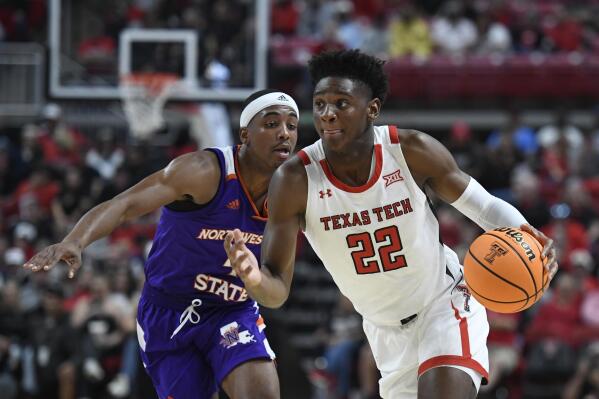 Texas Tech guard Elijah Fisher (22) dribbles the ball ahead of Northwestern State guard JaMonta' Black during the first half of an NCAA college basketball game Monday, Nov. 7, 2022, in Lubbock, Texas. (AP Photo/Justin Rex)