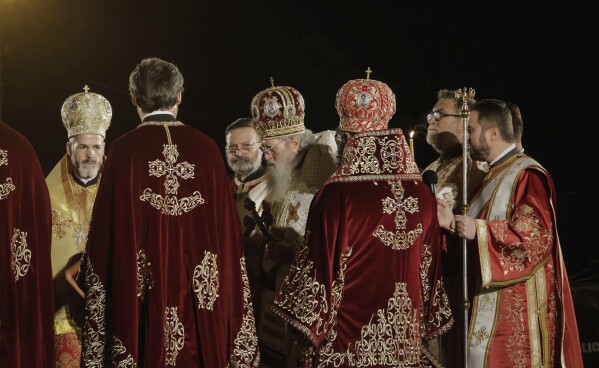 FILE - Clergymen and the head of the Bulgarian Orthodox Church, Patriarch Neophyte, center, take part in the festive midnight Mass in front of Alexander Nevsky cathedral in Sofia, Bulgaria, Sunday, April 19, 2020. Patriarch Neophyte of Bulgaria, who was the first elected head of the Orthodox Church in the post-communist Balkan country, died at a hospital in Sofia, at age 78. The Orthodox Holy Synod said Wednesday, March 13, 2024, in a statement that the patriarch had been hospitalized for four months for lung ailments. (AP Photo/Valentina Petrova, File)