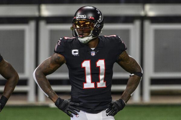 FILE - In this Sunday, Dec. 6, 2020, file photo, Atlanta Falcons wide receiver Julio Jones (11) warms up before an NFL football game against the New Orleans Saints in Atlanta. The Tennessee Titans have traded with the Atlanta Falcons for seven-time Pro Bowl wide receiver Julio Jones, a person familiar with the situation told The Associated Press.  (AP Photo/Danny Karnik, File)