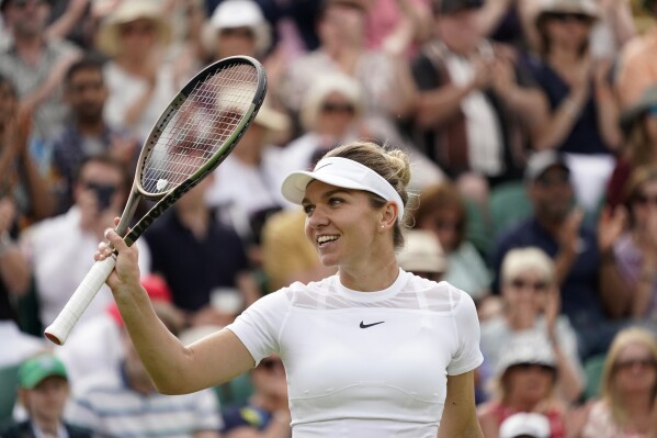 FILE Romania's Simona Halep celebrates after beating Poland's Magdalena Frech in their women's third round singles match on day six of the Wimbledon tennis championships in London, Saturday, July 2, 2022. Two-time Grand Slam champion Simona Halep has been cleared for an immediate return to tennis after sports’ highest court cut her ban for doping on appeal. (AP Photo/Alberto Pezzali, File)