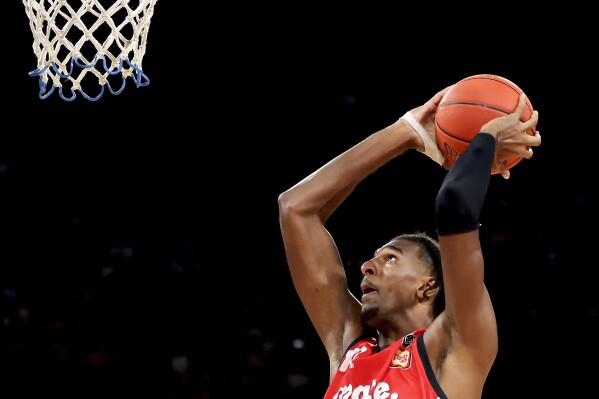France's Alexandre Sarr of the Wildcats shoots during the team's game against the Cairns Taipans in Perth, Australia, Saturday, Feb. 10, 2024. This year's NBA draft may be one of the weakest in years, with no clear-cut choice at No. 1 and an overall lack of depth. What it will likely have again this year: a French connection at the top. A year after San Antonio selected Victor Wembanyama with the No. 1 pick, fellow Frenchmen Sarr and Zaccharie Risacher could go 1-2 in the June 26 draft. (Richard Wainwright/AAP Image via AP)