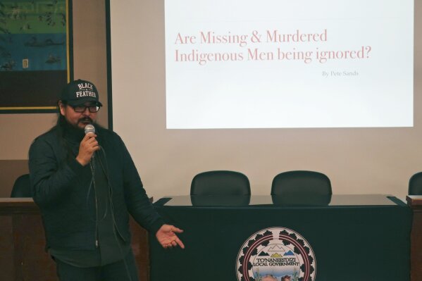 In this Jan. 14, 2020, photo, Navajo musician and filmmaker Pete Sands talks about missing indigenous men at a forum in Tuba City, Ariz. People were gathered to talk not about women and girls who have disappeared or been killed, but men. It's a shift from a larger movement focused on Native American women, who face some of the nation's highest homicide, sexual violence and domestic abuse rates. (AP Photo/Felicia Fonseca)