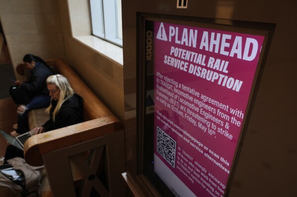 An electronic display advises commuters of potential NJ Transit service disruptions at the Secaucus Junction station in Secaucus, N.J., Wednesday, May 14, 2025. (AP Photo/Seth Wenig)