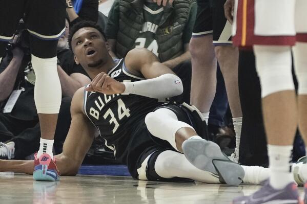 Milwaukee Bucks' Giannis Antetokounmpo lays on the ground after an injury during the first half in Game 1 of an NBA basketball first-round playoff game Sunday, April 16, 2023, in Milwaukee. (AP Photo/Morry Gash)