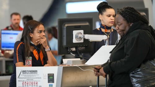 Jet Blue agents help a traveler, right, in the departures area of Terminal B at LaGuardia Airport, Tuesday, June 27, 2023, in New York. Travelers waited out widespread delays at U.S. airports on Tuesday, an ominous sign heading into the long July 4 holiday weekend, which is shaping up as the biggest test yet for airlines that are struggling to keep up with surging numbers of passengers. (AP Photo/Mary Altaffer)