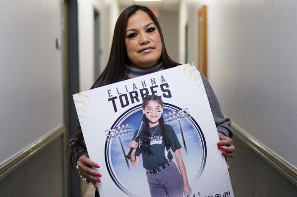 Sandra Torres, holds a photo of her daughter Eliahna, who was one of 19 students and two teachers killed in the school shooting in Uvalde, Texas, at her attorney's office, Monday, Nov. 28, 2022, in San Antonio, where she filed a federal lawsuit against the school district, police, city and the maker of the gun used in the slaying. The gun manufacturer claim filed with the group Everytown for Gun Safety is part of a new legal push nationally to hold firearms makers accountable in mass shootings despite federal laws that grant broad immunity by focusing on marketing. (AP Photo/Eric Gay)