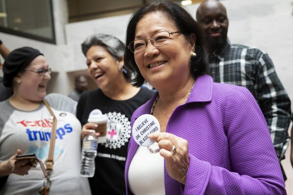 
              Sen. Mazie Hirono, D-Hawaii, a member of the Senate Judiciary Committee, is welcomed by protesters opposed to President Donald Trump's Supreme Court nominee, Brett Kavanaugh, as they demonstrate in the Hart Senate Office Building on Capitol Hill in Washington, Thursday, Sept. 20, 2018. Kavanaugh has denied stories of a sexual assault as alleged by California college professor Christine Blasey Ford. (AP Photo/J. Scott Applewhite)
            