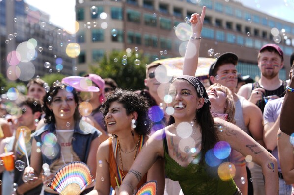 People watch the World Pride parade, Saturday, June 7, 2025, in Washington. (AP Photo/Julia Demaree Nikhinson)